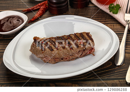 Grilled beef striploin steak with sauce 129886288