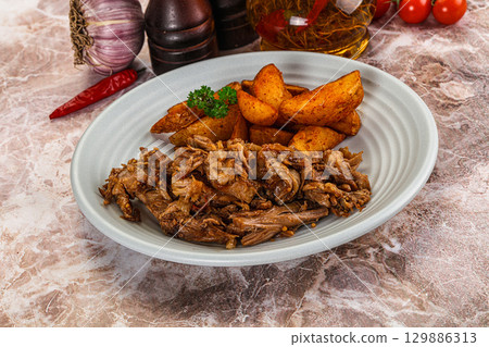 Baked shredded pork with potato Baked shredded pork with potato 129886313