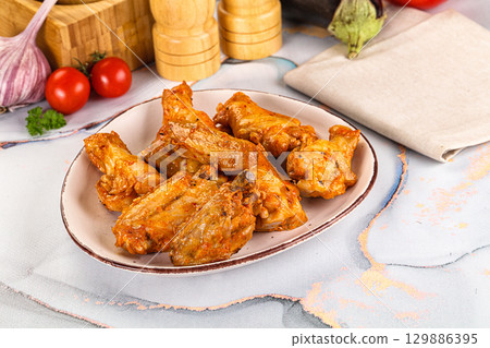 Grilled spicy chili chicken wings 129886395