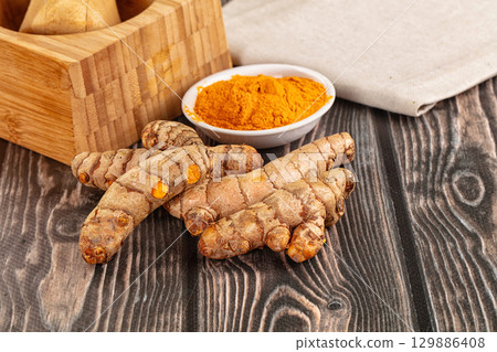 Fresh aroma tumeric roots heap Fresh aroma tumeric roots heap 129886408