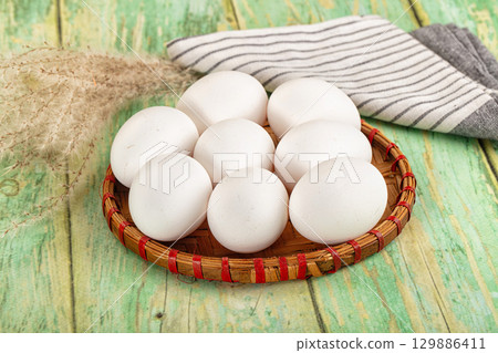 Raw white uncooked chicken eggs Raw white uncooked chicken eggs 129886411