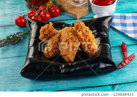 Golden crispy fried chicken wings 129886421