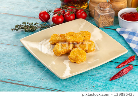 Golden crispy fried chicken nuggets 129886423