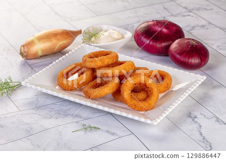 Golden fried onion rings snack 129886447