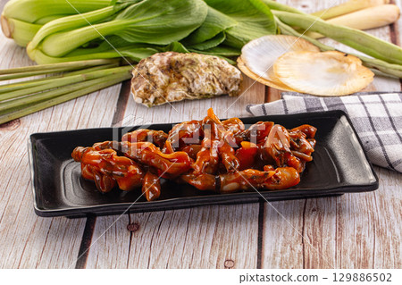 Razor shell mollusk with sauce 129886502