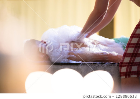 Back Massage with Foam.Therapist applying soap foam with hands on patient back during traditional bath ritual. Back Massage with Foam.Therapist applying soap foam with hands on patient back during traditional bath ritual. 129886638