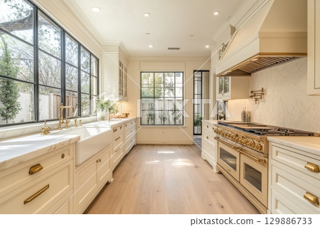 A large kitchen with a white sink and a white stove A large kitchen with a white sink and a white stove 129886733