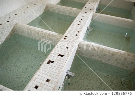 Top view of hydrotherapy stations with clean blue water, used for physiotherapy treatment of legs and arms. Top view of hydrotherapy stations with clean blue water, used for physiotherapy treatment of legs and arms. 129886776