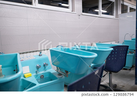 Hydrotherapy Machines in Spa Clinic.Modern hydrotherapy equipment in a clinical setting, used for hand and foot therapy treatments in rehabilitation centers. 129886794
