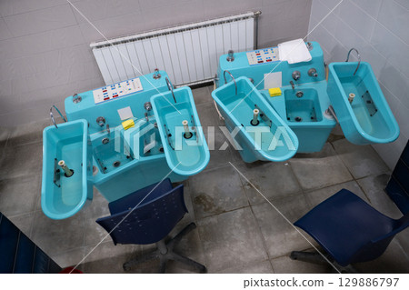 Hydrotherapy Machines in Spa Clinic.Modern hydrotherapy equipment in a clinical setting, used for hand and foot therapy treatments in rehabilitation centers. Hydrotherapy Machines in Spa Clinic.Modern hydrotherapy equipment in a clinical setting, used for hand and foot therapy treatments in rehabilitation centers. 129886797