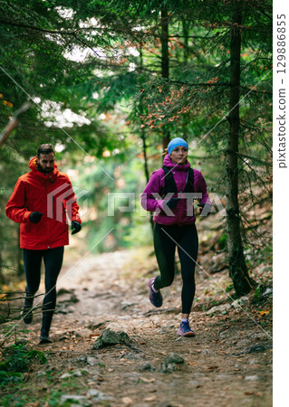 Happy Couple Running on a Forest Trail 129886855
