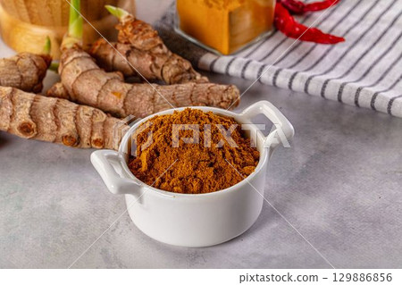 Indian spices - Curry powder heap 129886856