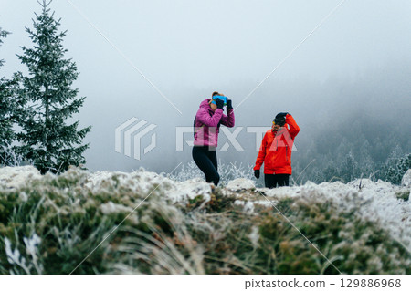 Trail running couple man and woman running on a mountain path Trail running couple man and woman running on a mountain path 129886968
