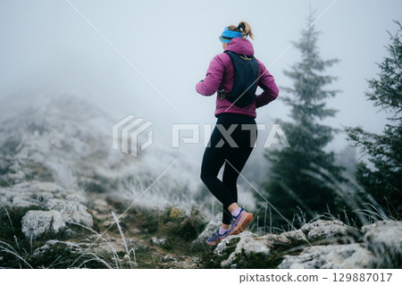 Trail Runner in Misty Mountain Landscape 129887017