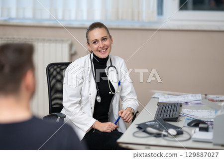 Female doctor consulting patient in office 129887027