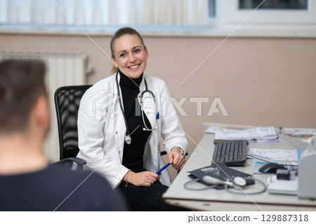 Female doctor consulting patient in office Female doctor consulting patient in office 129887318