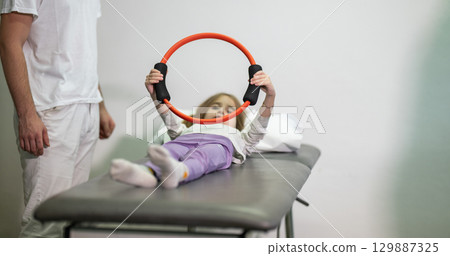 Child Doing Physical Therapy with Ring Child Doing Physical Therapy with Ring 129887325