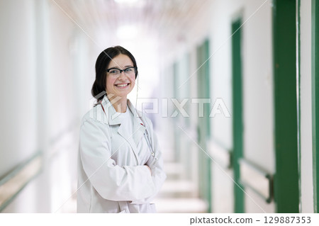 Doctor smiling in hospital hallway Doctor smiling in hospital hallway 129887353