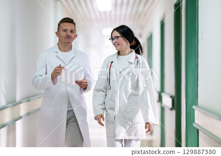 Doctors Walking in Hospital Hallway Doctors Walking in Hospital Hallway 129887380