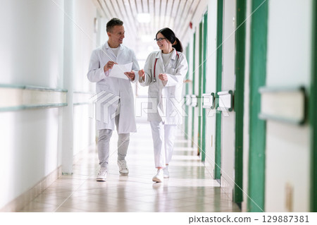 Doctors Walking in Hospital Hallway Doctors Walking in Hospital Hallway 129887381