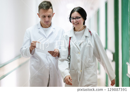 Doctors Walking in Hospital Hallway Doctors Walking in Hospital Hallway 129887391