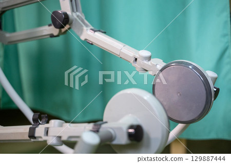 Leg Exercise on Rehabilitation Device.Top down view of a person using a rehabilitation machine for leg therapy, focusing on muscle training and mobility. 129887444