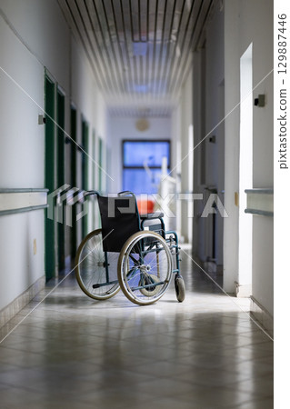 Empty Wheelchair in Hospital Hallway Empty Wheelchair in Hospital Hallway 129887446