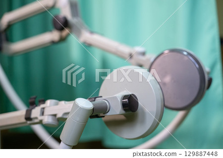 Leg Exercise on Rehabilitation Device.Top down view of a person using a rehabilitation machine for leg therapy, focusing on muscle training and mobility. 129887448