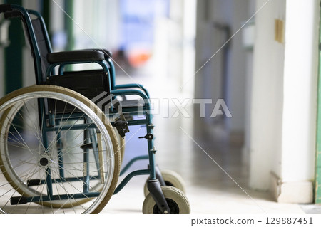 Empty Wheelchair in Hospital Hallway Empty Wheelchair in Hospital Hallway 129887451