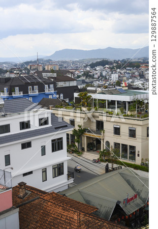Aerial view of the asian city with mountains on the horizon 129887564