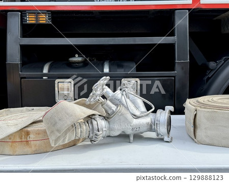 A water fire hose is lying on the lawn. High quality photo 129888123