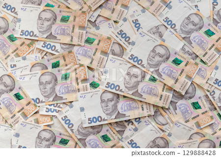 Background of ukrainian 500 hryvnia banknotes. Table full in hryvnias, big sum of money, richness 129888428