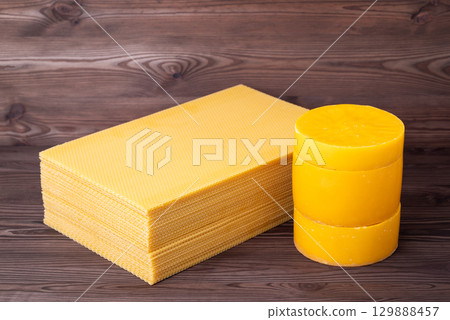 Beeswax in discs and honeycomb foundation wax frames. Making new wax foundation frames for beehives of reused wax Beeswax in discs and honeycomb foundation wax frames. Making new wax foundation frames for beehives of reused wax 129888457