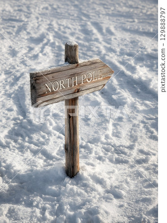 rustic wooden sign pointing to North Pole in snow 129888797