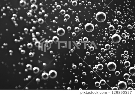 Dark oil with bubbles. Bubbles in liquid. Black and white. Oil concept. Oil business concept Dark oil with bubbles. Bubbles in liquid. Black and white. Oil concept. Oil business concept 129890557