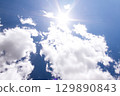 Bright sun and blue sky with clouds. Concept of abnormal heat 129890843