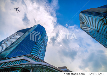 Tokyo cityscape in Japan: Aircraft passing by... Extreme heat, developed clouds over Takanawa Gateway City... = August 21st Tokyo cityscape in Japan: Aircraft passing by... Extreme heat, developed clouds over Takanawa Gateway City... = August 21st 129891246