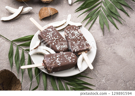 Coconut popsicles in chocolate glaze 129891594