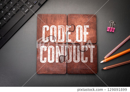 Code of Conduct Concept Shown on Puzzle Pieces in Office Workspace Setting Code of Conduct Concept Shown on Puzzle Pieces in Office Workspace Setting 129891899