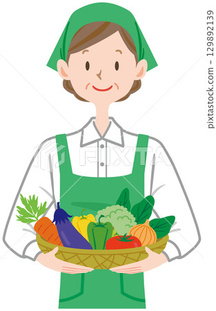 Clerk holding a vegetable basket, supermarket Clerk holding a vegetable basket, supermarket 129892139