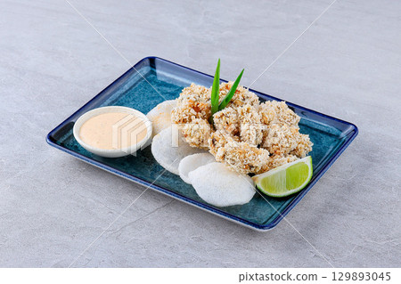 Crispy Panko Breaded Mussels with Sauce and Lime Crispy Panko Breaded Mussels with Sauce and Lime 129893045