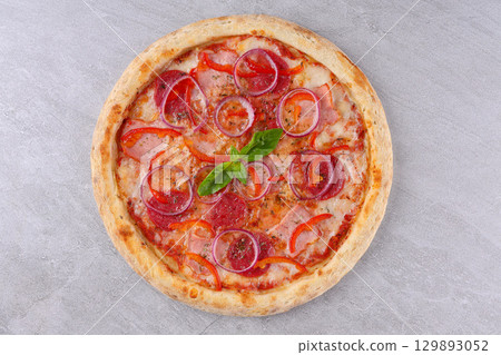 Spicy pizza topped with jalapenos, pepperoni, corn, red peppers, crispy onions, and drizzled with barbecue sauce Spicy pizza topped with jalapenos, pepperoni, corn, red peppers, crispy onions, and drizzled with barbecue sauce 129893052