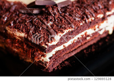 Festive layered chocolate cake with milk cream, dark chocolate cake Festive layered chocolate cake with milk cream, dark chocolate cake 129893128