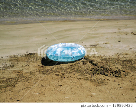 Swim ring and sandy beach Swim ring and sandy beach 129893423