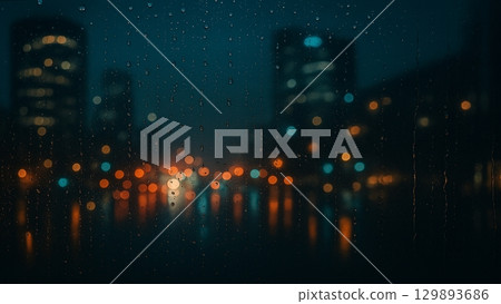Night city lights seen through a rain-soaked window 129893686