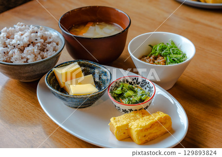 日本早餐套餐,包括雜糧米飯、味噌湯、玉子燒(蛋捲)和一份小菜。 日本早餐套餐,包括雜糧米飯、味噌湯、玉子燒(蛋捲)和一份小菜。 129893824