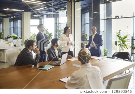 Presentation speech by business leader and speaker for corporate team in office conference room Presentation speech by business leader and speaker for corporate team in office conference room 129893846