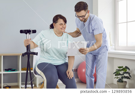 Woman with leg injury undergoes medical treatment and physiotherapy rehabilitation 129893856
