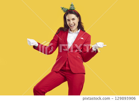 Crazy dancing emotional Christmas brunette woman wearing Santa style dancing on yellow background. Crazy dancing emotional Christmas brunette woman wearing Santa style dancing on yellow background. 129893906