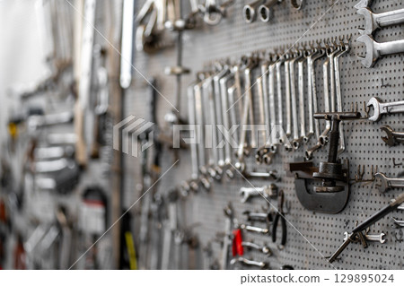 Assorted hand tools and socket wrenches neatly 129895024